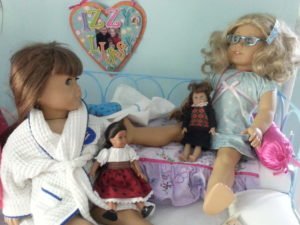 Dolls chatting in bed